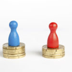 Wage gap concept with blue figure symbolizing men and red pawn women