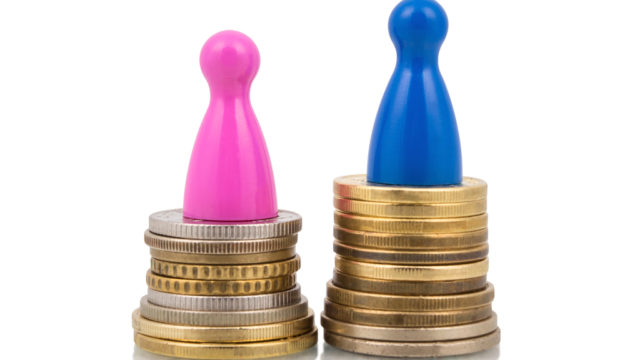 Pink and blue figures on different coin stacks. Concept for gender pay gap.