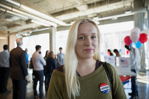 Portrait confident young woman at voter polling place