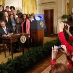 Women legislators take photos as U.S. President Barack Obama signs two new executive actions aimed at increasing transparency about women's pay during an event at the White House in Washington April 8, 2014. The executive actions are a continuing effort by the administration to ensure women are paid equally to their male counterparts for similar work. At left is Lilly Ledbetter who introduced Obama to speak. The first law Obama signed after taking office in 2009 was the Lilly Ledbetter Fair Pay Act, which extended time periods for employees to file claims for wages lost as a result of discrimination. 
REUTERS/Kevin Lamarque  (UNITED STATES - Tags: POLITICS BUSINESS EMPLOYMENT) - RTR3KG6D