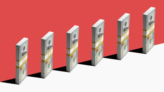 6 bundles of US $100 bills standing vertically on edge of white shelf, red background
